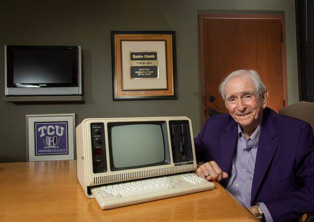 John Roach, former chairman and CEO of Tandy Corp., poses with one of the original Radio Shack TRS-80 Model 4P portable micro computers in his office on June 14, 2021. 